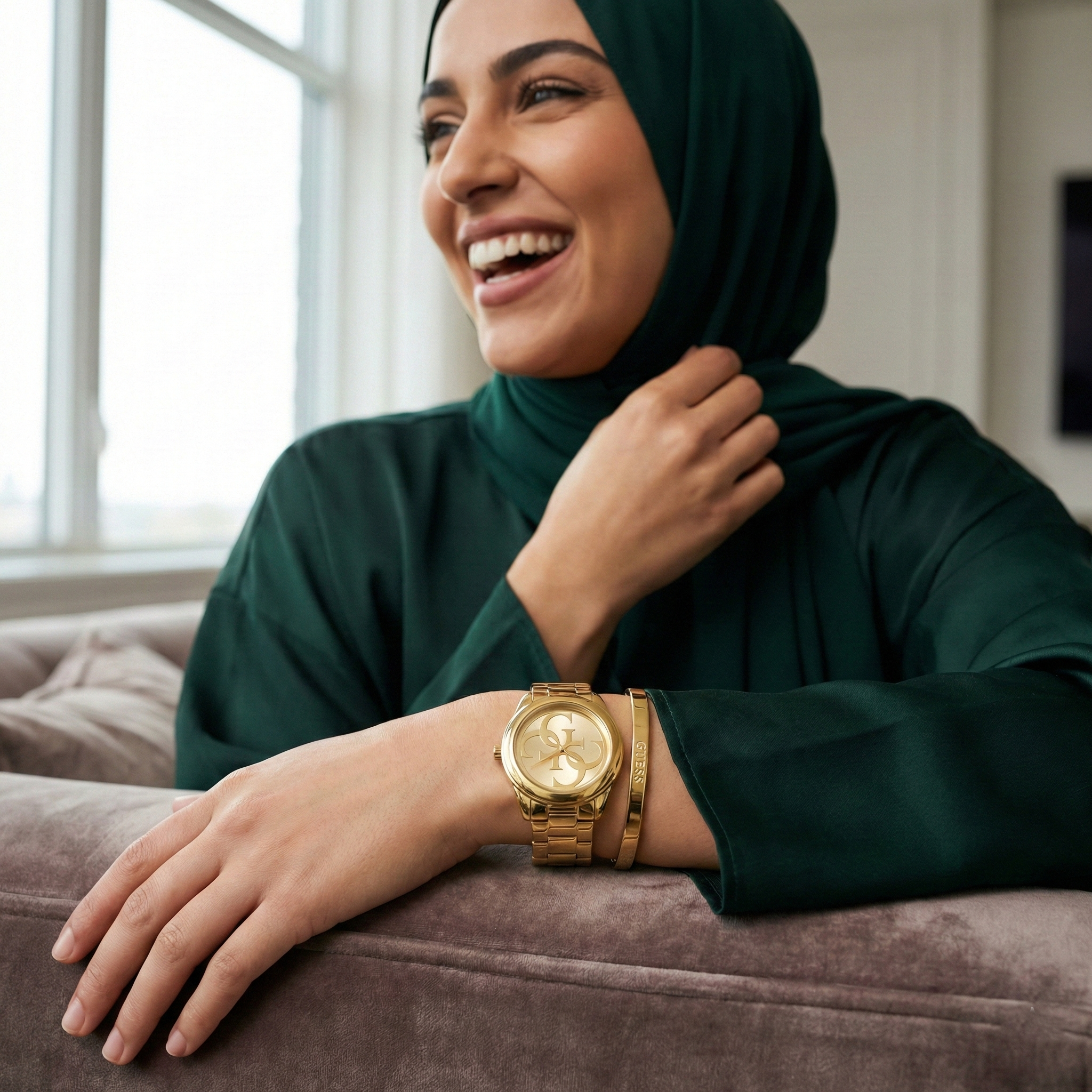 Woman wearing Guess G-Twist W1082L2 gold watch with a trendy casual outfit