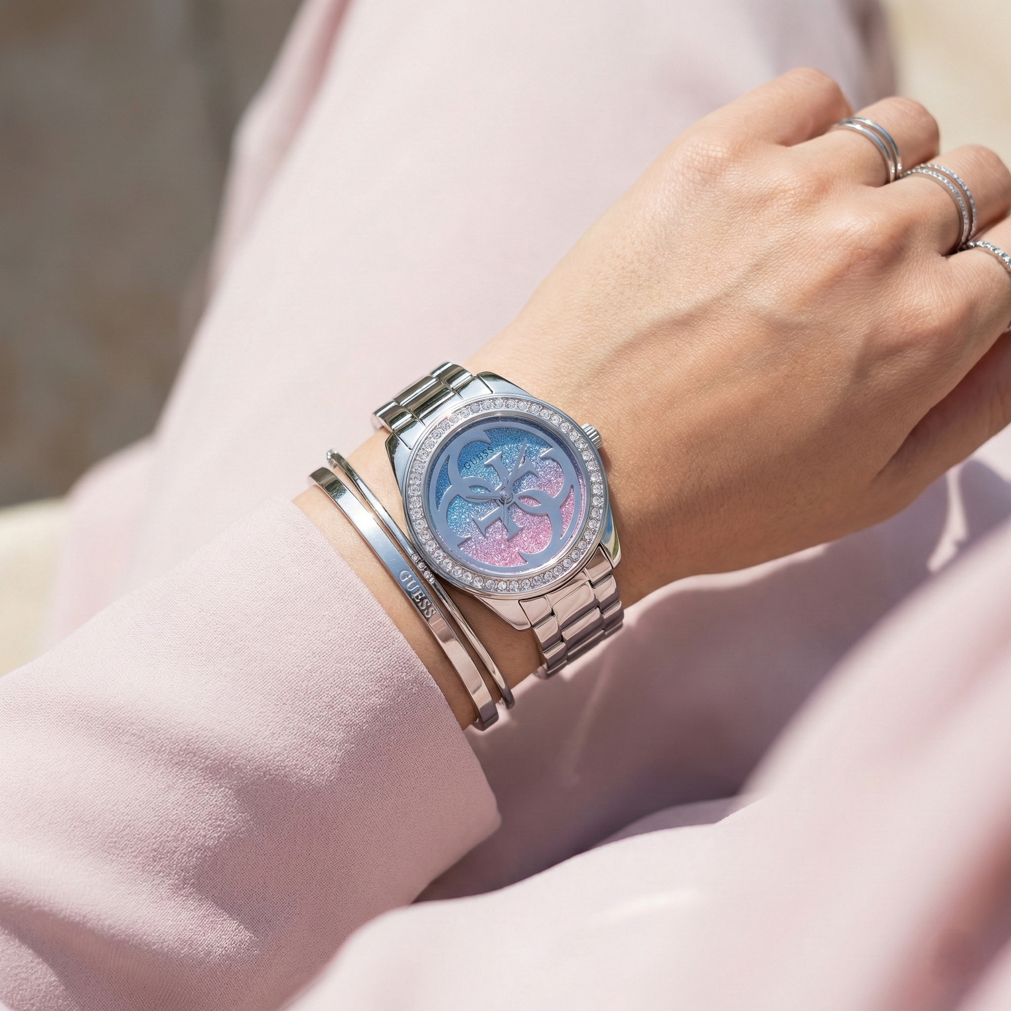 Female model wearing Guess G Twist W1201L1 silver watch with a trendy outfit