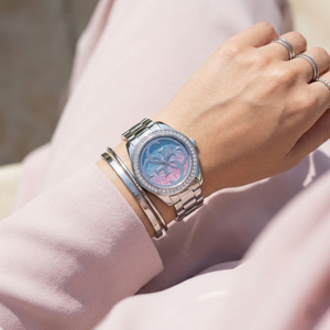 Female model wearing Guess G Twist W1201L1 silver watch with a trendy outfit