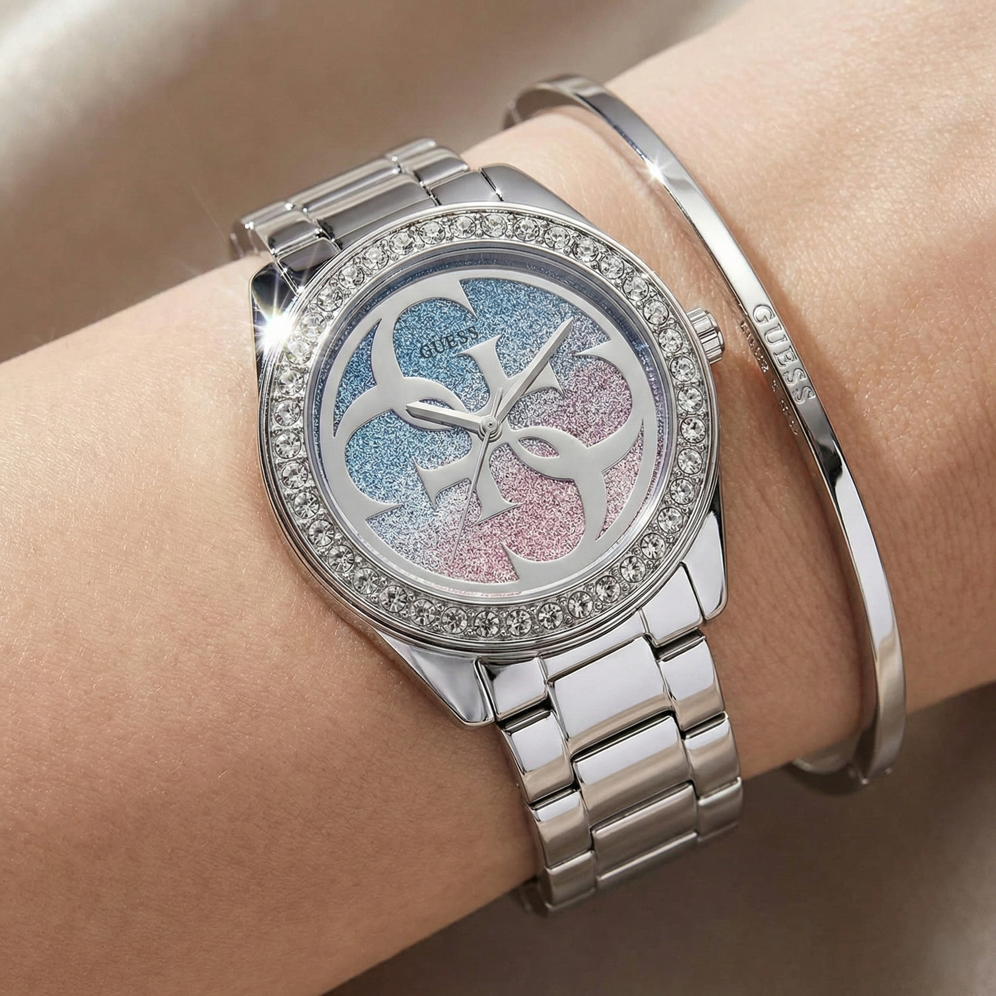 Close up shot of Guess G Twist W1201L1 watch on wrist showing the sparkling crystal bezel and 4G logo