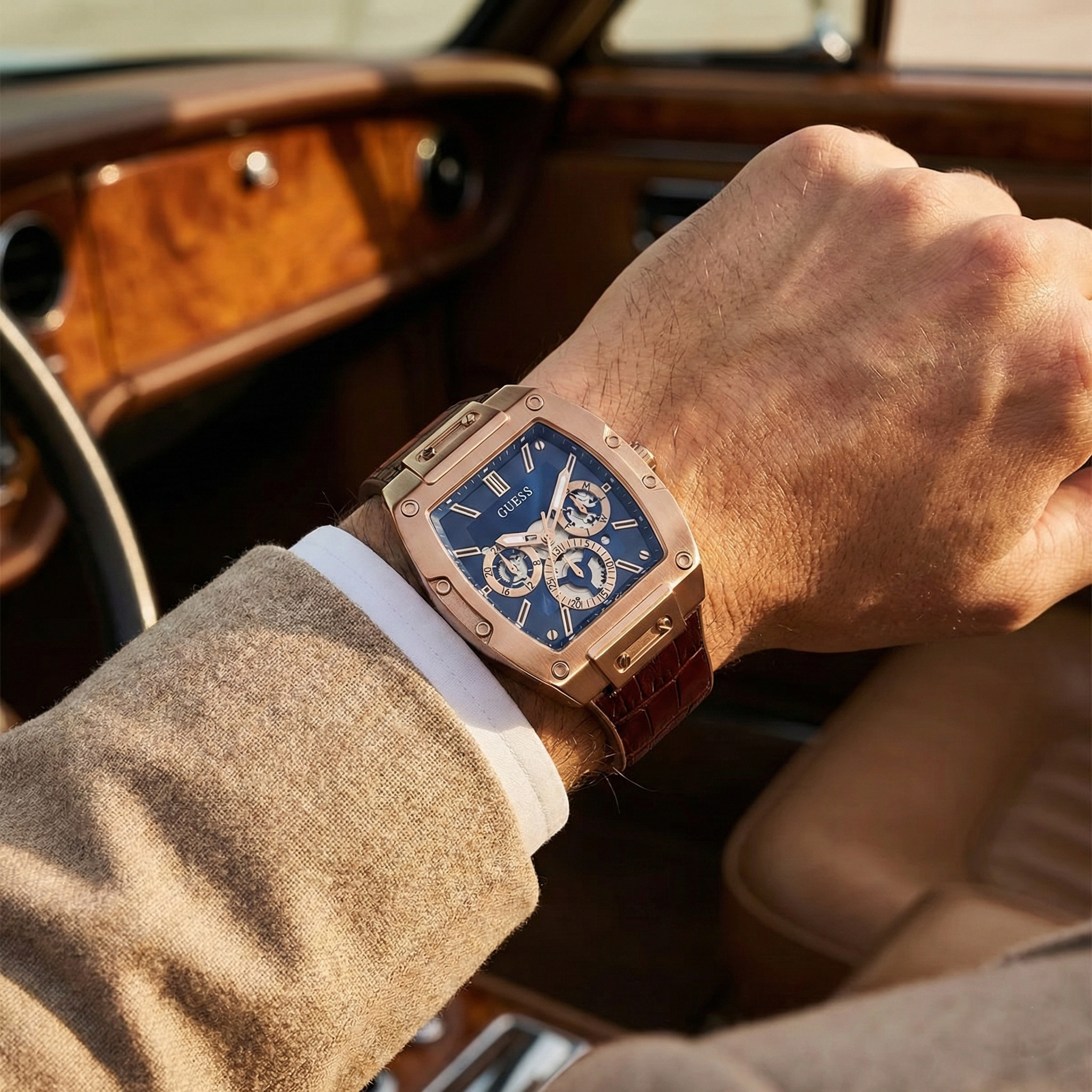 AI lifestyle shot of a man wearing Guess Phoenix GW0202G2 rose gold and leather watch