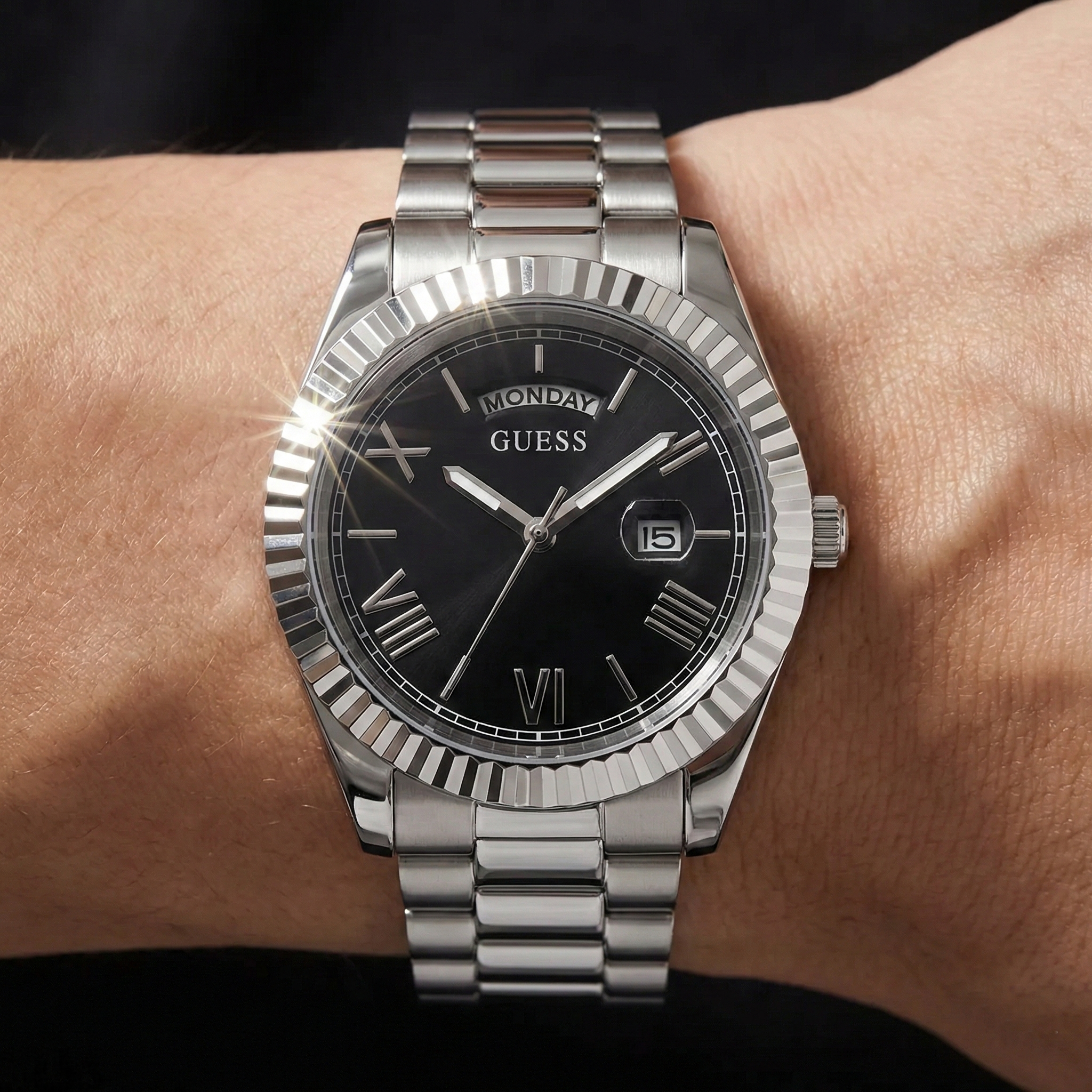Close up shot of Guess GW0265G1 on wrist highlighting the black sunray dial and day date window