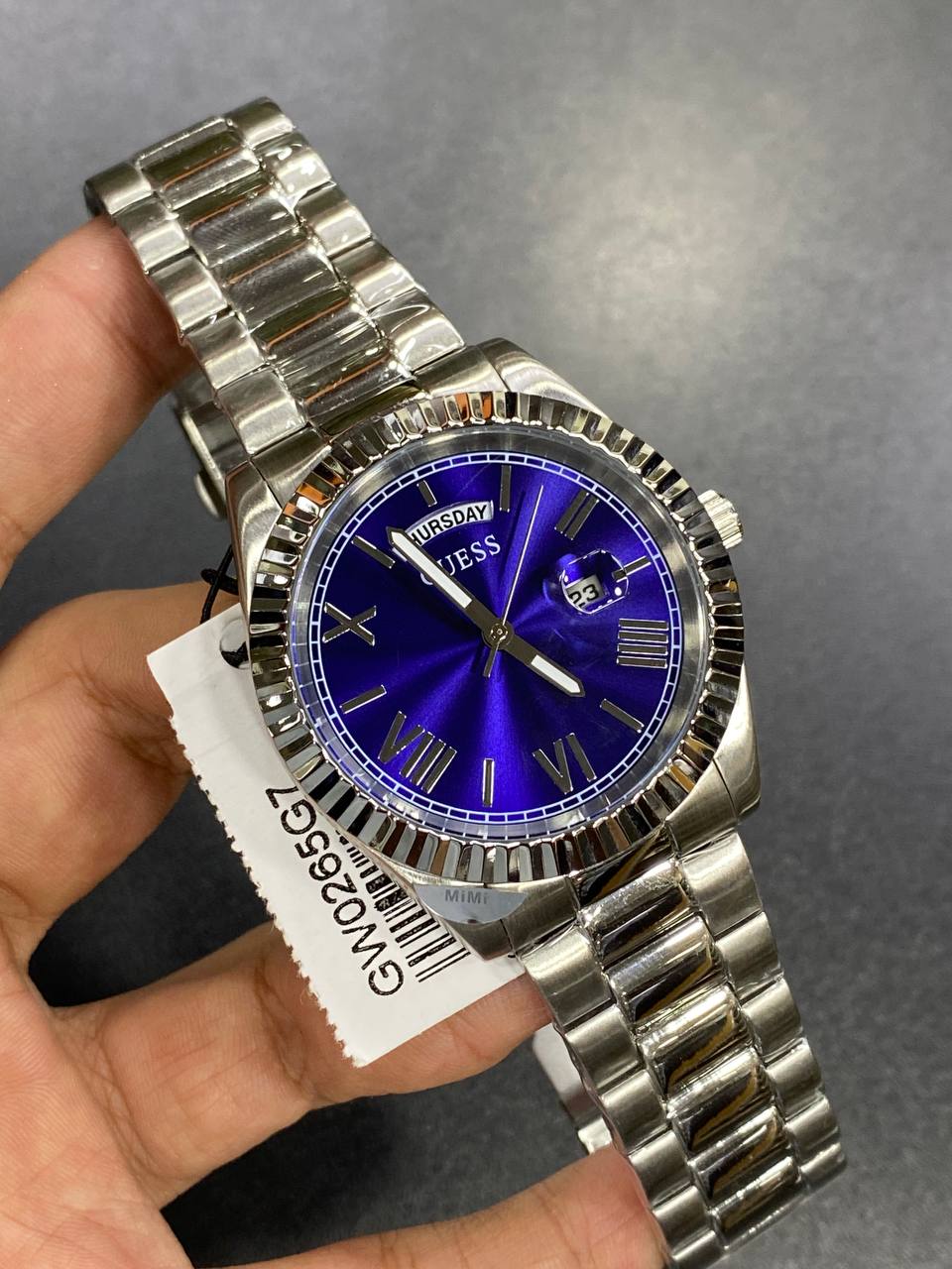 Authentic real-life photo of the Guess GW0265G7 showing actual silver shine and blue dial reflection in Egypt