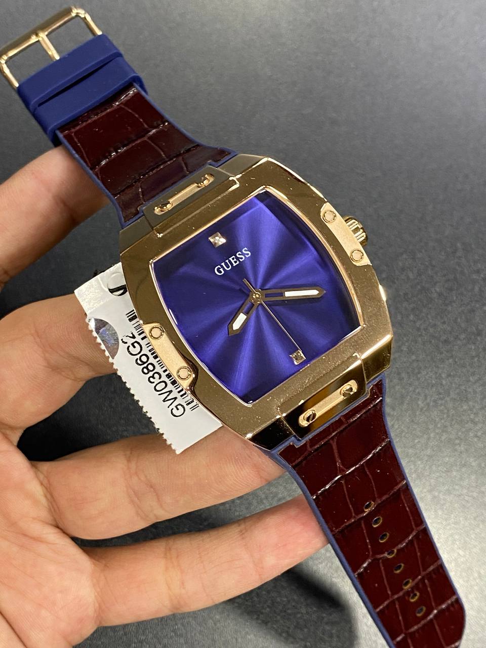 Real-life photo of Guess Phoenix GW0386G2 watch showing the actual gold and strap colors