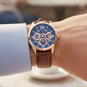Close up shot of Guess GW0389G3 on wrist highlighting the blue skeleton dial and rose gold hands