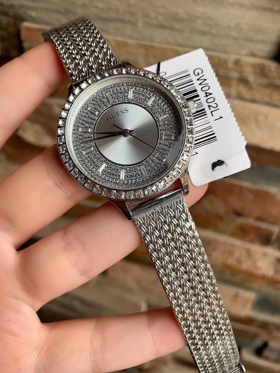 Authentic real-life photo of the Guess GW0402L1 showing actual silver mesh texture and crystal shine in Egypt