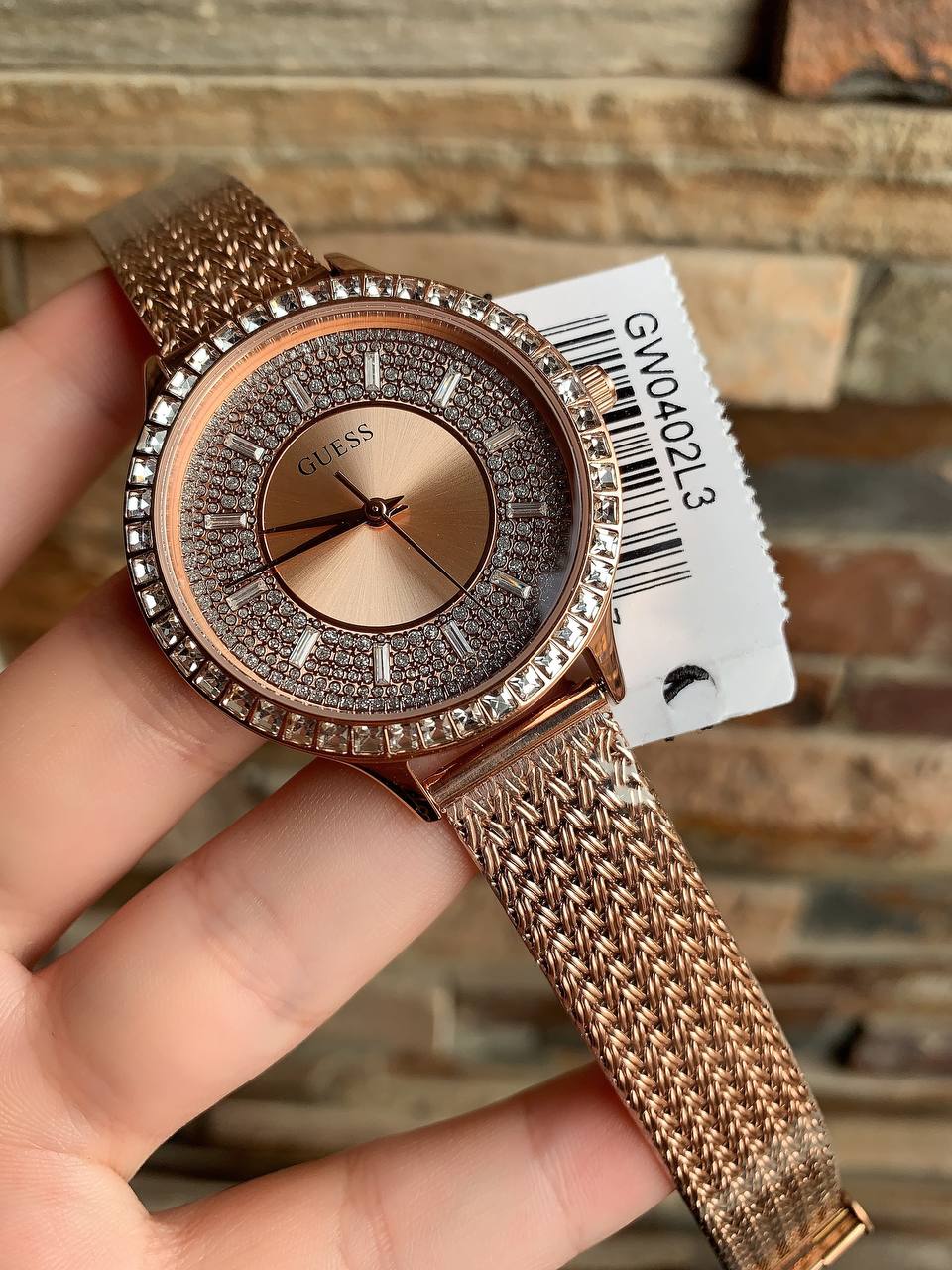 Authentic real-life photo of the Guess GW0402L3 showing actual rose gold mesh texture and crystal shine in Egypt
