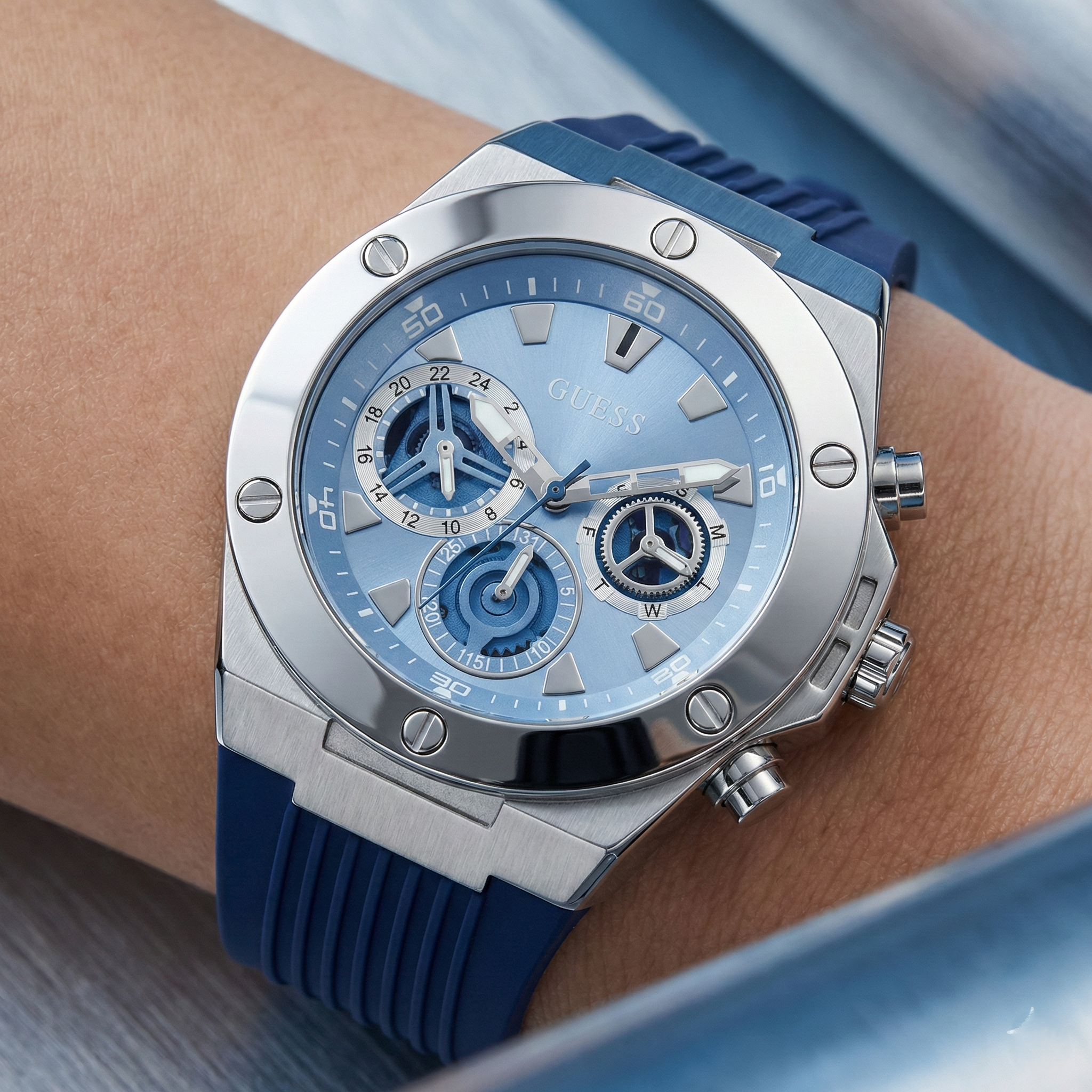 Detailed close-up of the blue multifunction dial and silver markers of Guess GW0417G1