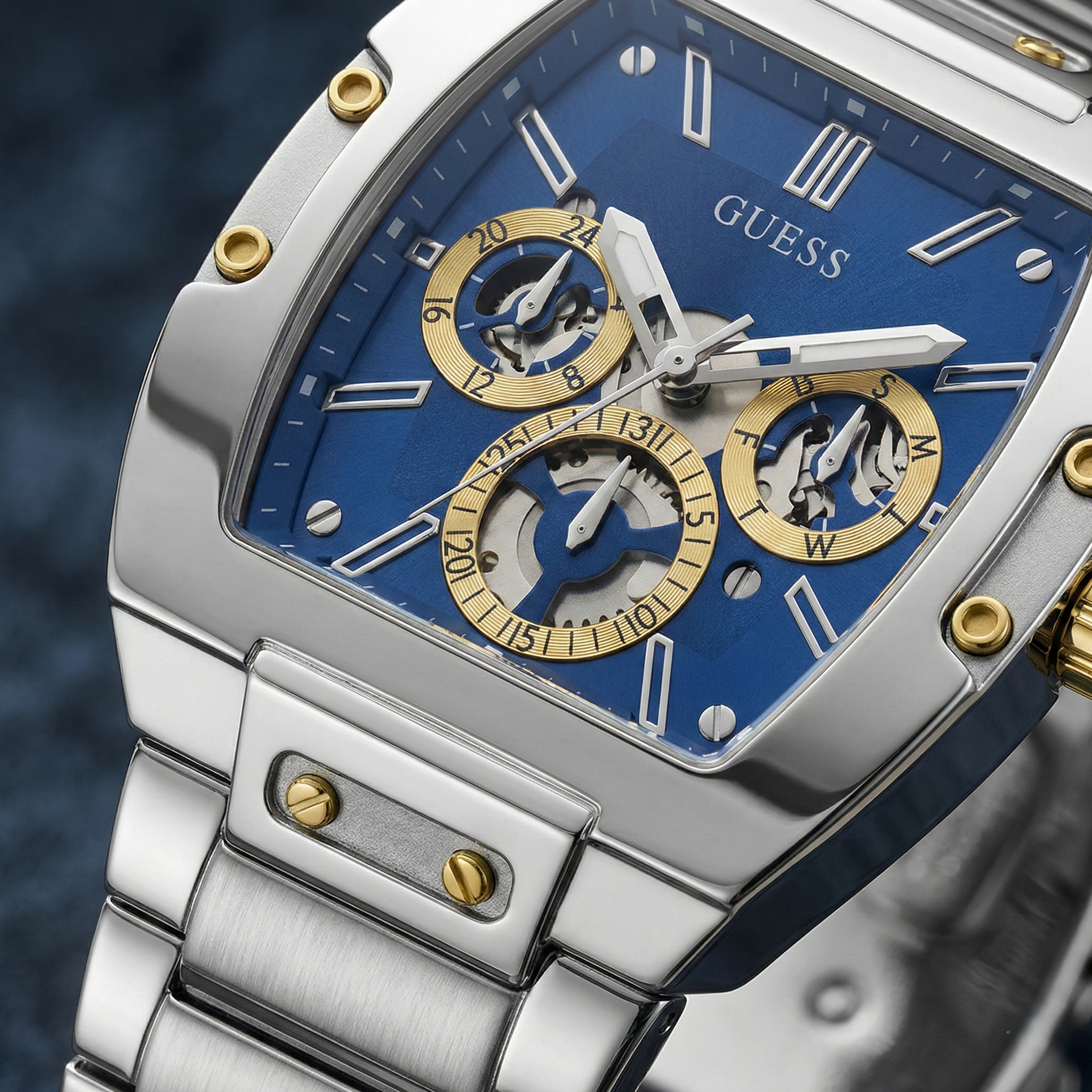 Detailed close-up of the blue skeleton dial and gold screws on Guess GW0456G5