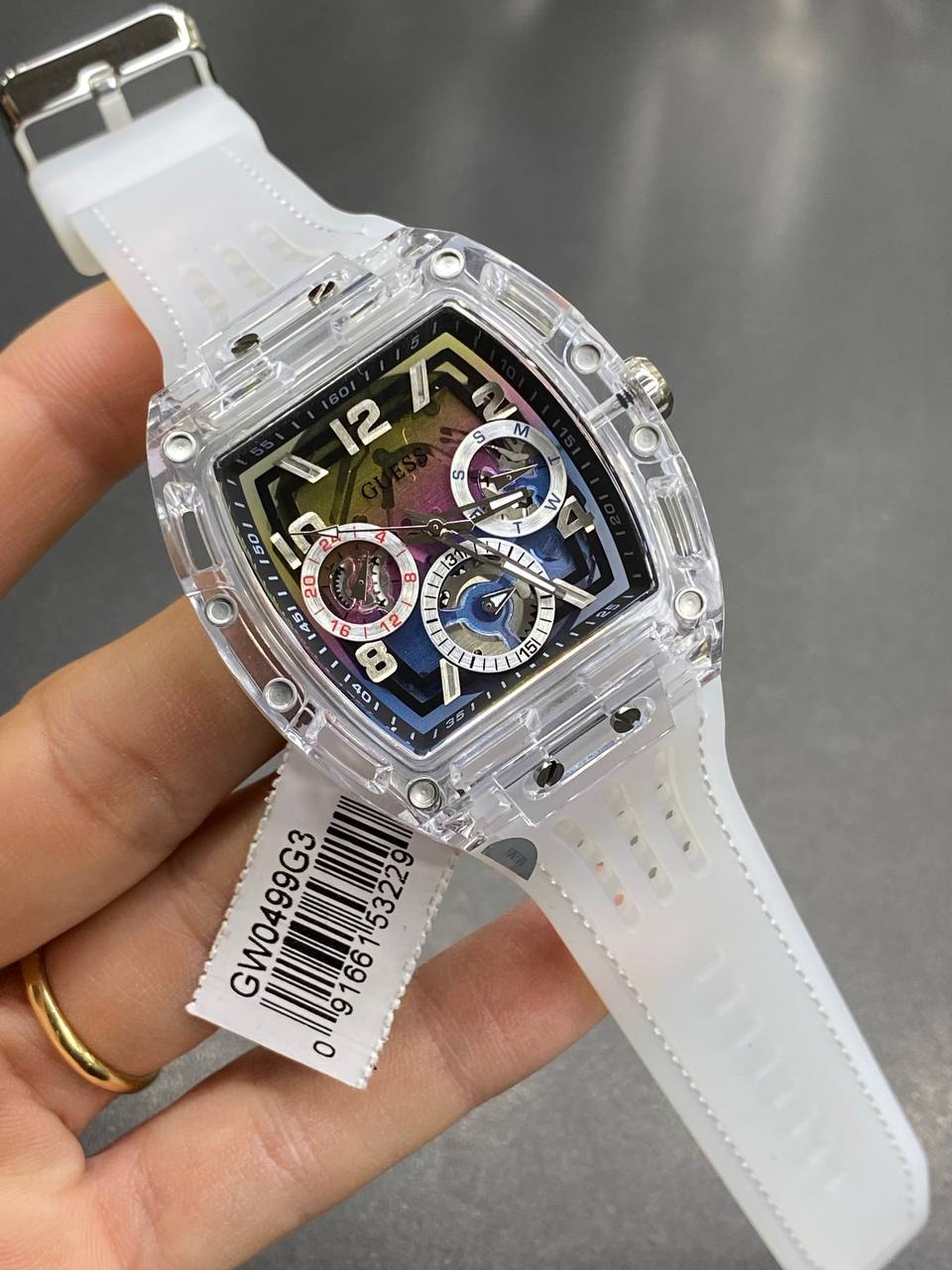 Real-life image of Guess GW0499G3 showing the vibrant rainbow colors and transparency