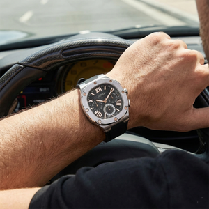 Male model wearing Guess GW0571G1 silver and black rubber watch with a smart sporty outfit