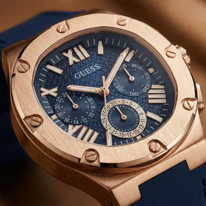 Close up shot of Guess GW0571G2 watch on wrist showing the navy blue textured dial and rose gold bezel screws