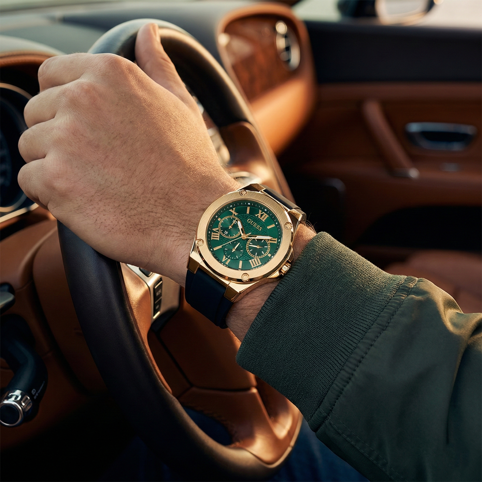 Male model wearing Guess GW0571G3 gold and green watch with a premium sporty fashion outfit