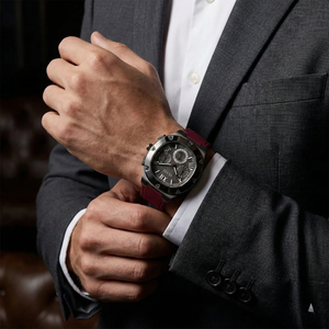Male model wearing Guess GW0571G4 gunmetal and red watch with a bold sporty outfit
