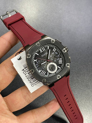 Authentic real-life photo of the Guess GW0571G4 showing actual gunmetal finish and red strap color in Egypt