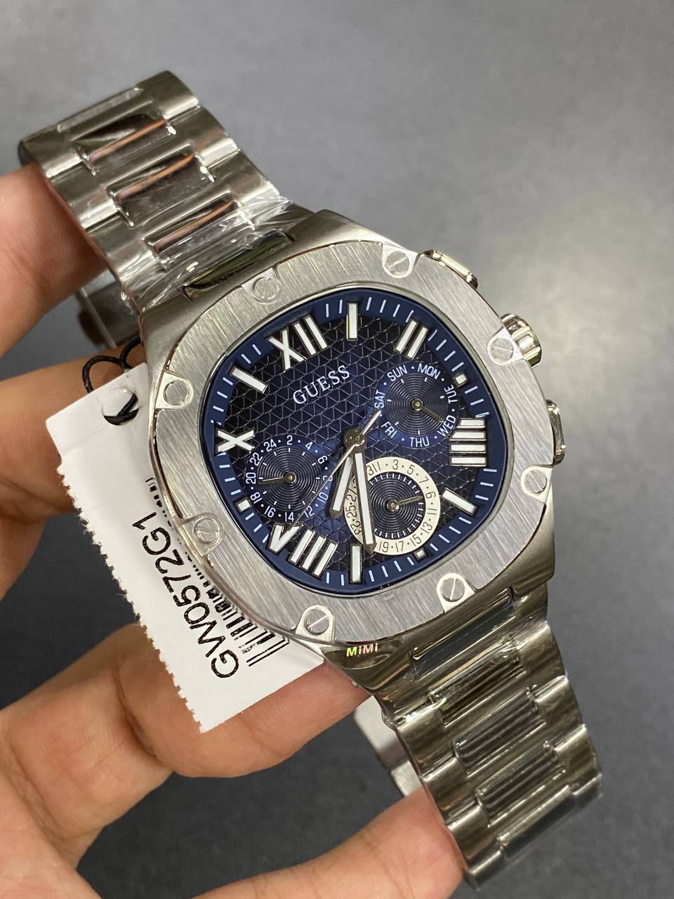 Real-life image of Guess GW0572G1 showing the actual blue dial contrast and silver shine