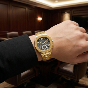 Male model wearing Guess GW0572G2 gold and black watch with a premium fashion outfit
