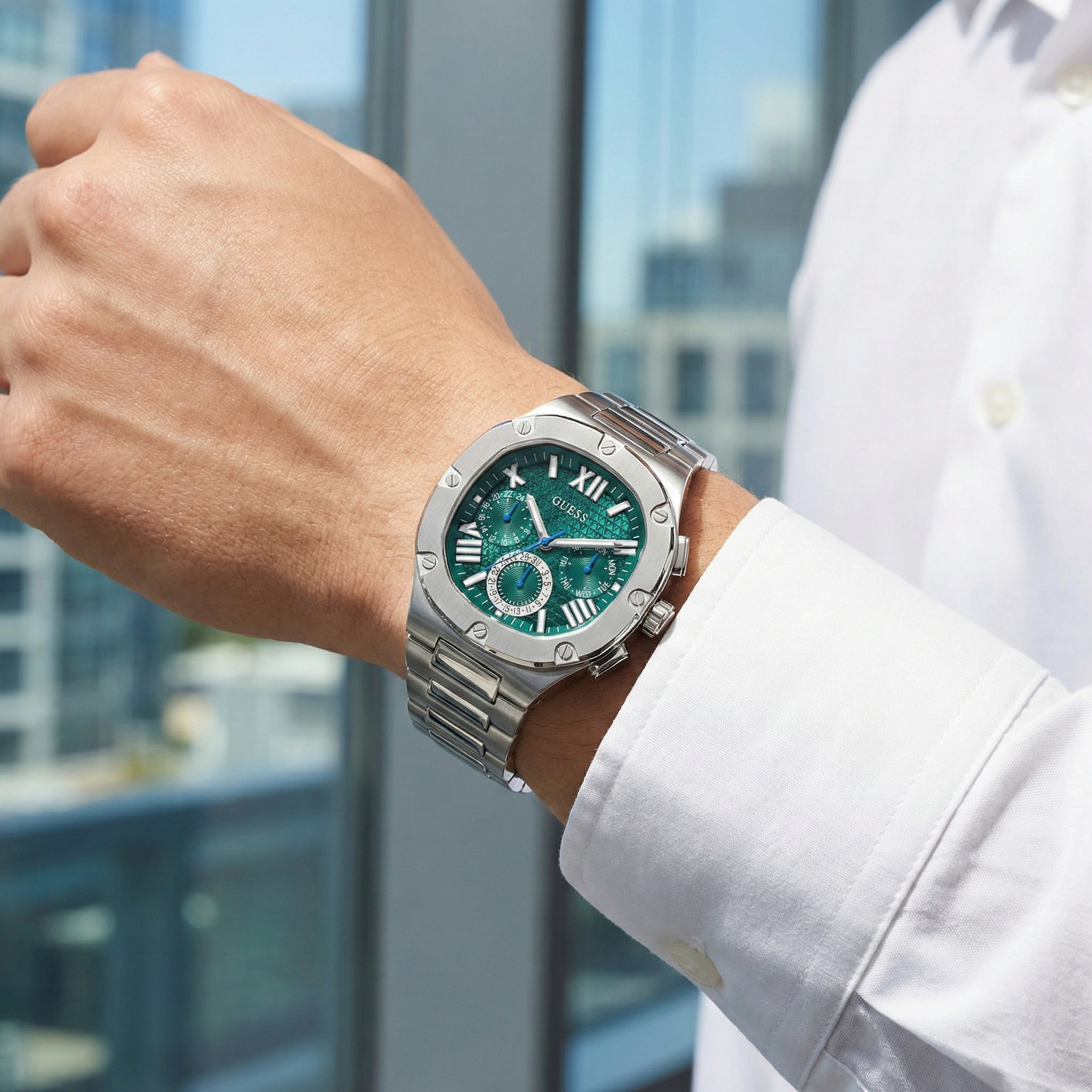 AI lifestyle shot of a man wearing the elegant silver and green Guess Headline watch