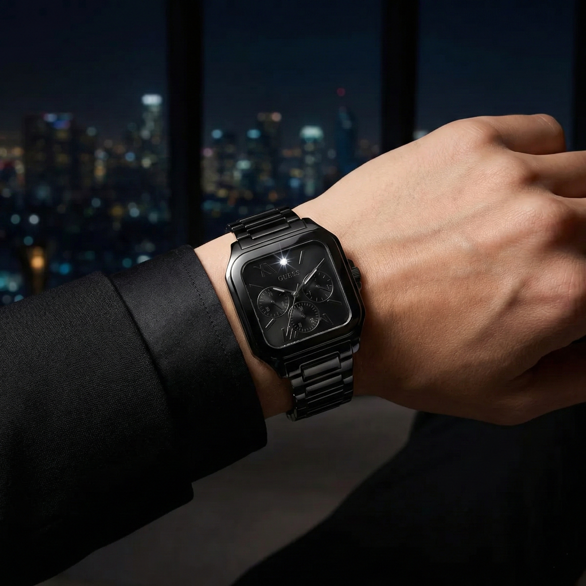 Male model wearing Guess GW0631G2 black square watch with a high-fashion formal outfit
