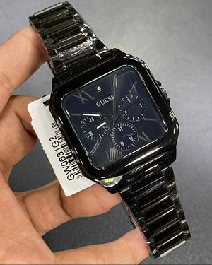 Authentic real-life photo of the Guess GW0631G2 watch showing actual black color depth and square proportions