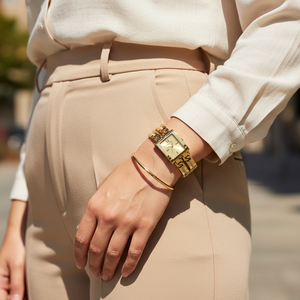 Woman wearing Guess GW0668L2 gold watch with an elegant evening dress