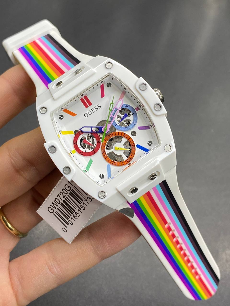 Real-life photo of Guess GW0720G1 showing the actual rainbow colors and white finish
