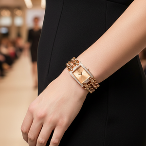 Woman wearing Guess Mod Heavy Metal W0072L3 rose gold watch as a bracelet with an evening dress