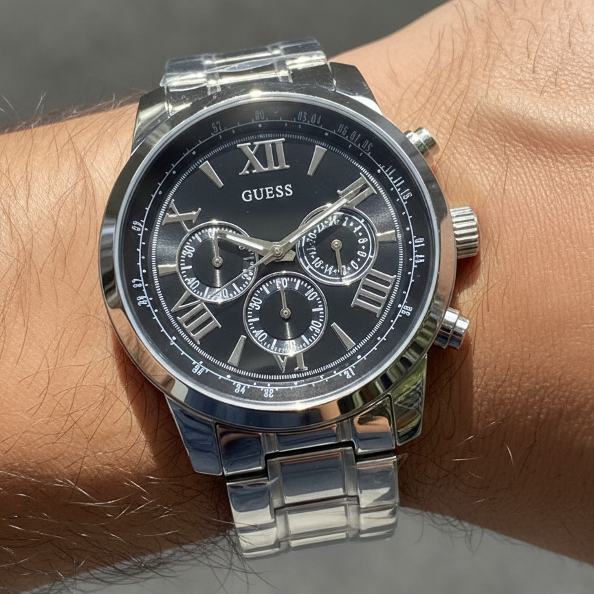 Close up shot of Guess Horizon W0379G1 watch on wrist showing the black dial and silver roman numerals