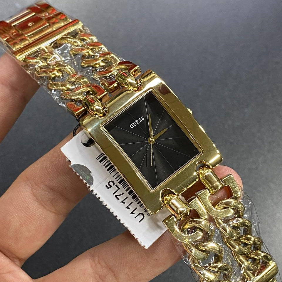 Authentic real-life photo of the Guess Mod Heavy Metal U1117L5 watch showing actual gold chain and black dial