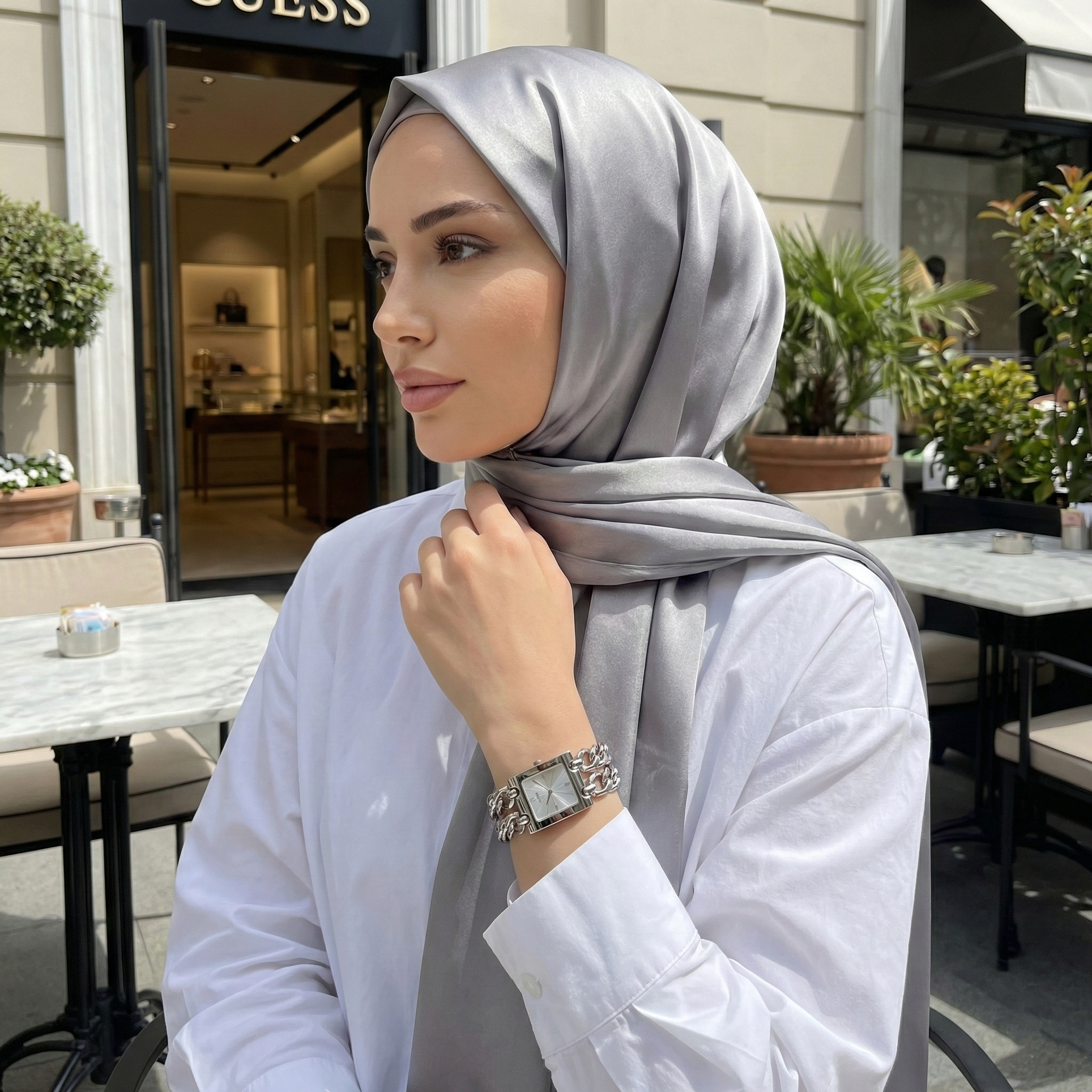 Woman wearing Guess Mod Heavy Metal W1117L1 silver watch with a chic modern outfit