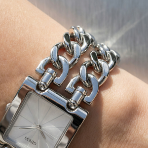 Close up shot of Guess W1117L1 watch on wrist showing the minimalist silver dial and polished bezel