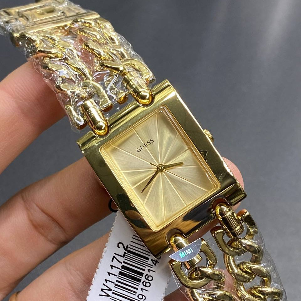 Authentic real-life photo of the Guess Mod Heavy Metal W1117L2 watch showing actual gold finish