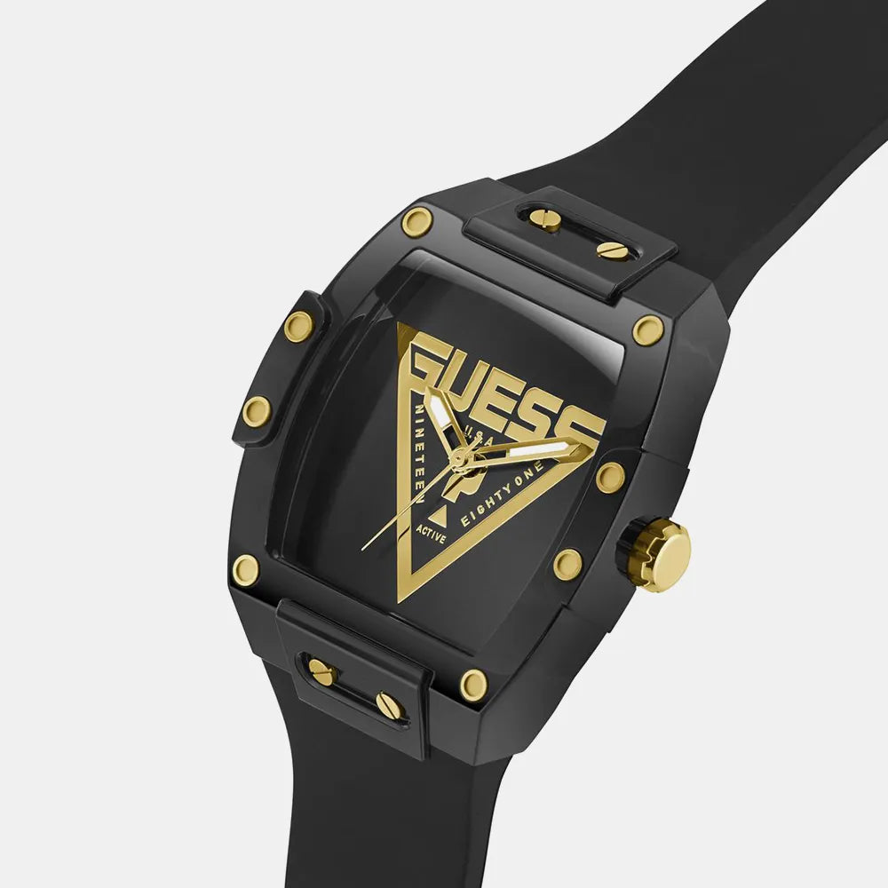 Black and gold Guess watch on a light gray background