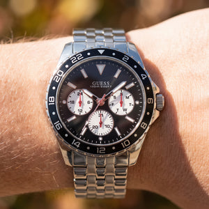 Wrist shot of Guess Odyssey W1107G1 watch showing the silver metal band