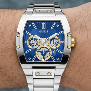 Close up shot of Guess Phoenix GW0456G5 watch on wrist showing the blue sunray dial and gold screws
