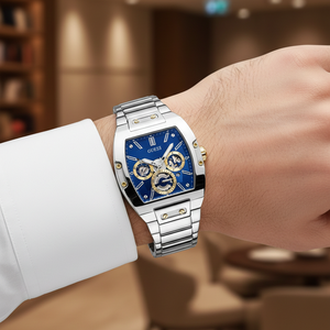 Male model wearing Guess Phoenix GW0456G5 silver and blue watch with a sophisticated outfit