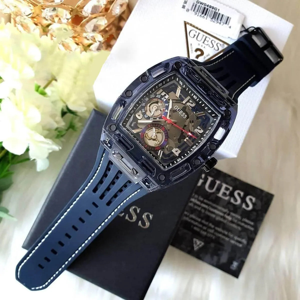Authentic real-life photo of the Guess Phoenix GW0499G1 watch showing actual transparent blue finish and multifunction sub-dials