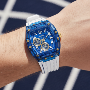 Close up shot of Guess Phoenix GW0499G6 watch on wrist showing the blue multifunction dial and gold screw details