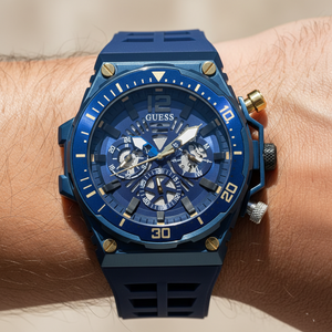 Close up shot of Guess Treasure GW0443G1 watch on wrist showing the blue skeleton dial details