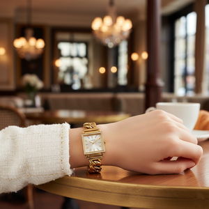 Woman wearing Guess Vanity W1030L2 gold square watch with a classic elegant outfit
