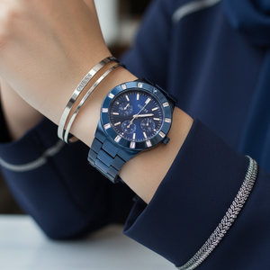 Female model wearing Guess W0027L3 blue metal watch with a trendy fashion outfit