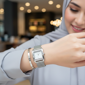 Female model wearing Guess W0127L1 silver mesh watch with a classic elegant outfit