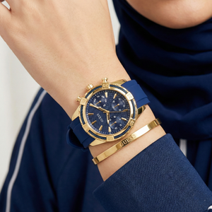 AI lifestyle shot of a woman wearing Guess Catalina W0562L2 blue rubber watch