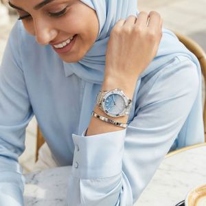 AI lifestyle shot of a woman wearing Guess Confetti W0774L6 silver watch