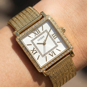 Close up shot of Guess W0826L2 on wrist showing the white square dial and gold roman numerals