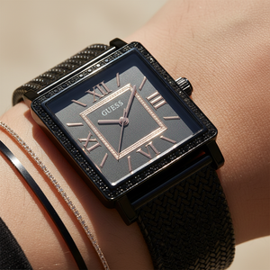 Close up shot of Guess W0826L4 on wrist showing the black square dial and rose gold roman numerals