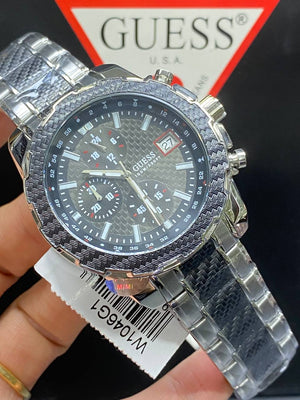 Authentic real-life photo of the Guess W1046G1 showing actual silver steel shine and black dial texture in Egypt