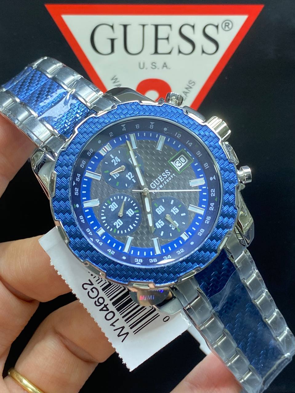 Authentic real-life photo of the Guess W1046G2 showing actual blue bezel shine and grey dial texture in Egypt