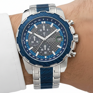 Close up shot of Guess W1046G2 on wrist highlighting the grey carbon fiber dial and blue bezel