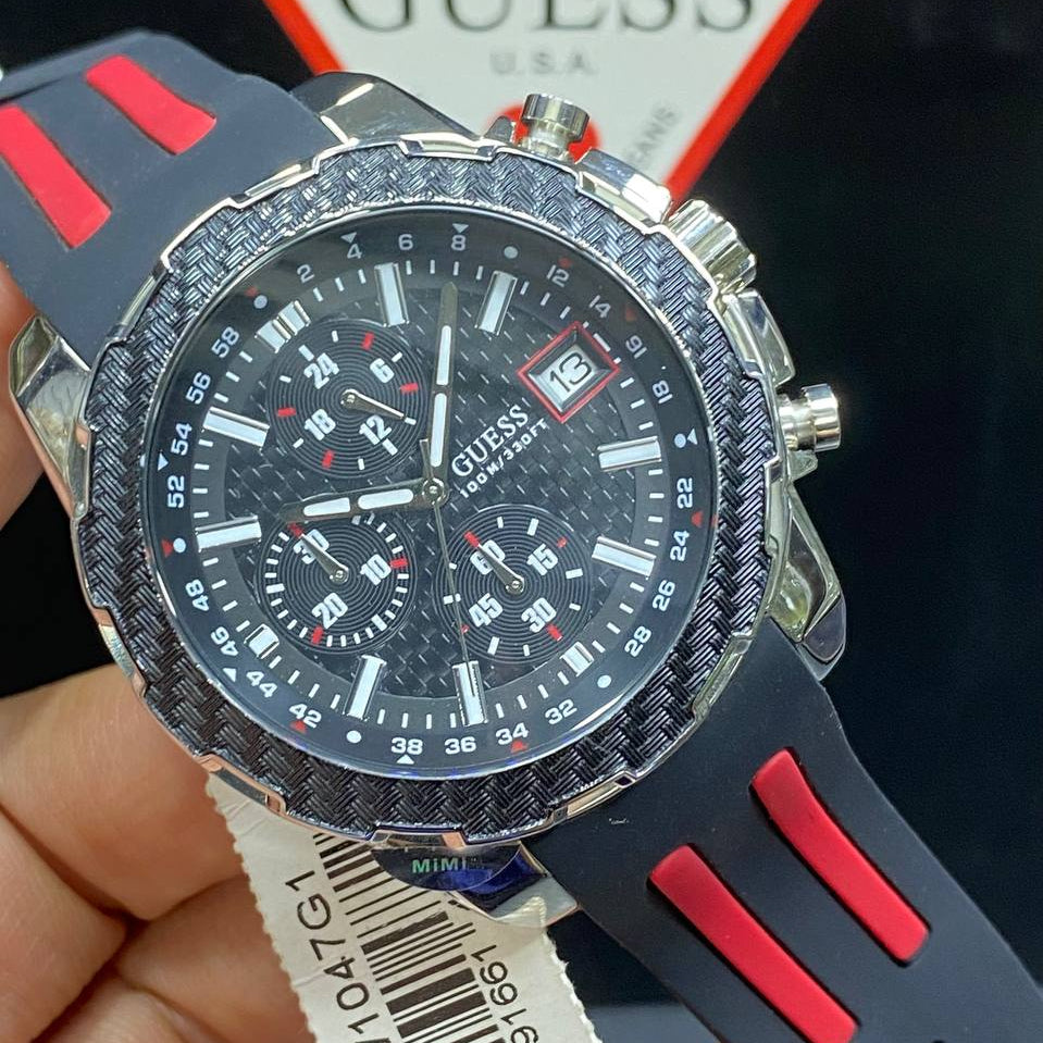 Authentic real-life photo of the Guess W1047G1 showing actual carbon look and rubber texture in Egypt